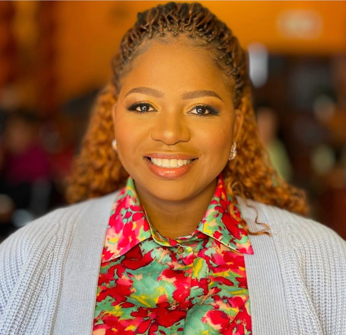 A picture of Dr Kentse Mpolokeng smiling in a white coat